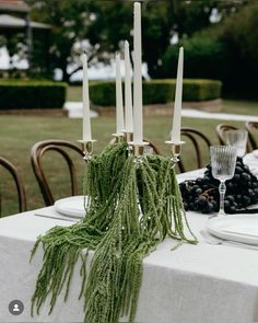 the table is set with candles and fruit