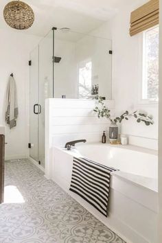 a white bathroom with black and white decor