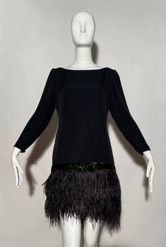 Black cocktail dress. Ostrich feather skirt. Beaded trim. Wide neckline. Zipper on back. Rayon and acetate. Lined. Made in USA. *Condition: excellent vintage condition. No visible flaws. Measurements Taken Laying Flat (inches)-- Shoulder to Shoulder: 16 in. Sleeve Length: 21 in. Bust: 34 in. Waist: 31 in. Hip: 34 in. Length: 34 in. Marked size: 6 US Elegant Flapper Dress With Feather Trim, Silk Evening Dress With Feather Trim, Glamorous Feather Trim Flapper Dress For Evening, Evening Flapper Dress With Feather Trim, Formal Fitted Dress With Ostrich Feathers, Elegant Flapper Dress With Feather Trim For Cocktail, Elegant Feather Trim Flapper Dress For Cocktail, Elegant Cocktail Flapper Dress With Feather Trim, Fitted Feathered Flapper Dress For Cocktail