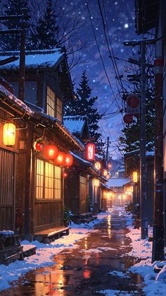 a snowy street at night with lanterns hanging from the buildings and snow on the ground