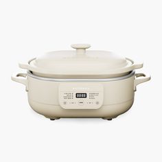 an electric pressure cooker with the lid open on a white background, it is also used to cook food