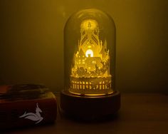 a glass dome with a clock on it next to a red box and yellow light