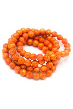 two strands of orange beads on a white background