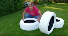 a woman kneeling down next to an inflatable object