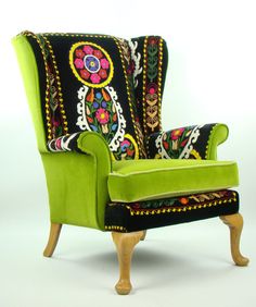 an upholstered green chair with colorful designs on it