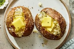 two pieces of bread with cheese on them sitting on a plate next to some flowers