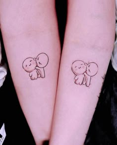 two small tattoos on the arms of girls with elephants and hearts drawn on their backs