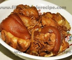 a white bowl filled with food on top of a table