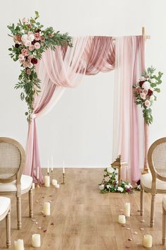 the wedding arch is decorated with flowers and candles