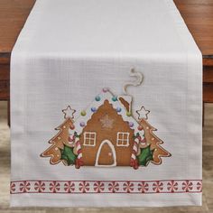 a table runner with a gingerbread house on it