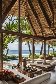 a living room with couches and tables near the ocean