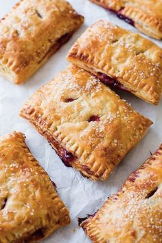 small pastries are lined up on a sheet of wax paper and ready to be eaten