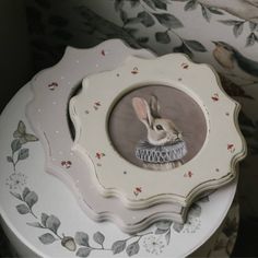 a white plate with a painting of a rabbit on it