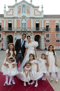 the bride and groom are posing with their flower girls