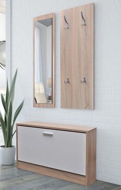 a white and wooden dresser sitting next to a mirror on the wall in a room