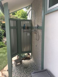 an open door leading to a shower in a backyard