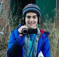 a young man taking a selfie with his camera