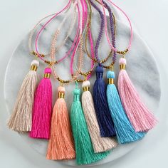 This beaded tassel necklace is made with a soft silky tassel and top-of-the-line glass beads, giving it a sophisticated style that women of all ages will love. Pull-over-the-head length makes it easy to wear but a closure in the back allows this piece to be wrapped around the wrist as a Adjustable Beaded Tassel Necklace, Adjustable Lariat Beaded Necklaces With Tassels, Adjustable Tassel Necklace For Beach, Adjustable Beaded Necklaces With Tassels For Beach, Beaded Tassel Necklace As A Gift, Adjustable Beaded Necklace With Tassels For Beach, Adjustable Colorful Beads Tassel Necklace For Beach, Lariat Beaded Necklace With Tassels For Gift, Gift Lariat Beaded Necklace With Tassels