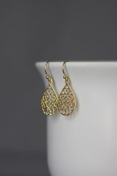 "Beautifully detailed 14k gold vermeil filigree teardrop charms simply dangle from 18k gold vermeil balled earwires. These very lightweight go-with-everything earrings complete any outfit for daytime or evening. Gold filigree charms: 12.5x23mm Total length of earrings: 1 1/4\" All gold is gold vermeil. A matching necklace is available... www.etsy.com/listing/942775100/gold-filigree-pendant-necklace As the owner, maker, designer, and curator of this shop, I take great pride in providing you with Gold Filigree Earrings For Gift, Gold Filigree Earrings As Gift, Gold Plated Teardrop Earrings For Celebration, Single Teardrop Earring For Celebration, Delicate Gold Earrings For Anniversary, Teardrop Earrings With Intricate Design As Gift, Classic Gold Teardrop Dangle Earrings, Teardrop Earrings With Intricate Design, Filigree Brass Teardrop Earrings