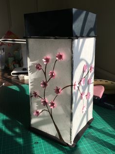 a white box with pink flowers painted on it