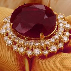 19.26 Carats Impressive Red Ruby and Diamond 14K Yellow Gold Ring Suggested Replacement Value $8,400.00 Total Red Ruby Weight is: 17.36 Carats (glass filled) Ruby Measures: 15.74 x 13.96mm Natural Round Diamonds Weight: 1.90 Carats (color G / Clarity VS2-SI1) Ring total weight: 11.6 grams Disclaimer: all weights, measurements and colors are approximate and may vary slightly from the listed dimensions or as seen in the image. All pictures are magnified to show the smallest of details. Please, ref Luxury Ruby Halo Ring, Luxury Red Ruby Ring With Vvs Clarity, Luxury Red Gemstone Diamond Ring, Luxury Red Diamond Ring With Gemstone, Luxury Red Ruby Ring For Formal Occasions, Luxury Ruby Ring With Diamond In Yellow Gold, Luxury Ruby And Diamond Ring In Yellow Gold, Red Ruby Round Ring, Luxury, Luxury Red Ruby Round Ring