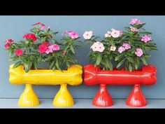 two plastic toys with flowers in them sitting next to each other