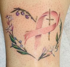 a pink ribbon in the shape of a heart with flowers around it and a cross