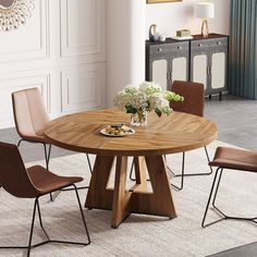 a round wooden table with four chairs around it and a vase on the table top