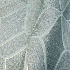 an up close view of a fabric with white and silver leaves on it's surface