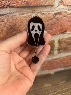 "Glittered Ghost face badge reel!  NEW: Make it interchangeable! PRODUCT INFO:  - 2\" Acrylic Blank -Most acrylics have been done with sublimation ink, sometimes it may be permanent vinyl -Most acrylics have been hand glittered on the back side and sealed with UV resin for extra protection. Some badge reels DO NOT have glitter.  - Acrylics are glued onto the badge reel with E6000 glue -Choose between an alligator swivel clip (which you can clip to pockets, scrubs, or any other loose articles of Black Badge Reel, Halloween Gift, Black Badge Reel For Halloween Gift, Black Halloween Badge Reel Gift, Halloween Gift Black Badge Reel, Themed Black Badge Reel For Gifts, Themed Black Badge Reel As A Gift, Themed Black Badge Reel For Gift, Themed Black Badge Reel Gift, Themed Black Badge Holders For Gift