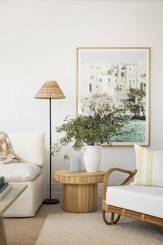 a living room filled with furniture and a painting on the wall