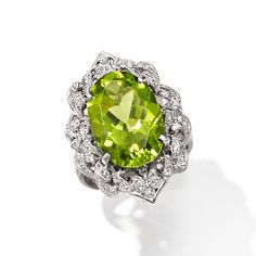 Ross-Simons - C. 2000 Vintage 7.89ct Peridot, .23ct t. w. Diamond Cocktail Ring Oval Cut Size 5.75. C. 2000. The vibrant tones of this eye-catching ring will call to mind lush greenery and spring days. A sizable 7.89 carat peridot oval glistens amid a decorative halo of beaming platinum, sparked with .23 ct. t. w. round brilliant-cut diamonds. 1" wide. Diamond and peridot ring. Exclusive, one-of-a-kind Estate Jewelry. Peridot birthstones are the perfect gift for August birthdays. Fine Jewelry Peridot Rings With Brilliant Cut, Peridot Rings With Brilliant Cut In Fine Jewelry Style, Formal Peridot Diamond Ring With Prong Setting, Formal Oval Peridot Diamond Ring, Formal Peridot Diamond Ring With Center Stone, Oval Peridot Diamond Ring For Formal Occasions, Fine Jewelry Peridot Gemstones For Formal Occasions, Elegant Peridot Gemstones For Anniversary, Formal Peridot Rings Fine Jewelry