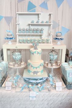 a table topped with lots of cakes and desserts