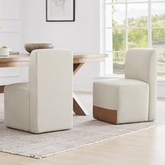 a dining room table with two chairs and a bench in front of it, along with a rug on the floor