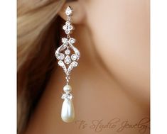 a close up view of a woman's ear with pearls and diamonds on it