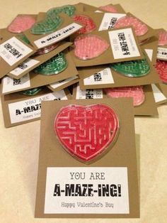 a pile of valentine's day cards sitting on top of a table next to each other