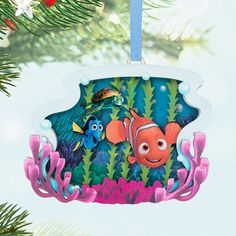 an ornament hanging from a christmas tree with finding nemo and dory