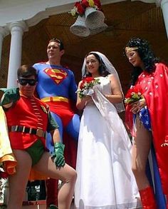 a group of people dressed up as superman and wonder woman pose for a photo on their wedding day