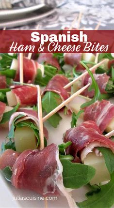 ham and cheese cocktail sticks on a white plate with green leafy garnish