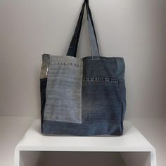 Denim handmade shoulder bag width 39cm length 40cm.  ✨Each bag is a one of a kind as it is made from responsibility sourced denim, and made by hand in our UK based studio. ✨The bags are a square shape and have a panel on the bottom which allows for plenty of storage space. There is also a pocket on each side panel. Our super cute "reworked by Ruthie" label is featured on the side of the bag. ✨The bags are made of a single layer of denim and are finished with an overlocked stitch on the inside of Rectangular Denim Blue Shoulder Bag For Everyday Use, Rectangular Dark Wash Shoulder Bag For Everyday Use, Everyday Rectangular Dark Wash Shoulder Bag, Daily Use Denim Shoulder Bag With Flat Pocket, Vintage Denim Blue Shoulder Bag For Everyday, Vintage Denim Blue Everyday Shoulder Bag, Rectangular Dark Wash Bag For Everyday Use, Daily Use Dark Wash Cotton Shoulder Bag, Vintage Denim Tote Shoulder Bag