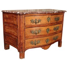 an old wooden dresser with marble top