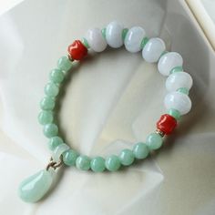 "We promise with our shop credit that all jadeite products are natural Myanmar jadeites, every high class jadeite bangle will come with international appraisal certificate for free, the rest of the jadeite products will come with certificate with a $50 extra charge up on request. Thank you! Real Burmese Jadeite jade bracelet/Natural multi color beaded jade bracelet/Handmade bracelet/One of a kind unique bracelet/Icy real jade  Item Details Handmade: Yes Designing and producing location: Denver, The United States When: it is custom made to order Handmade duration: 1-2 weeks Metal: natural Myanmar jadeite  Size of the bangle: Bead size 12mm, 6.5mm The bracelet length is 6.5-7\" and it is flexible.  length could be customized. Side stones: red agates.                                    Shippi Colorful Jade Beaded Bracelets For Healing, Handmade White Jade Beaded Bracelets, Multicolor Jade Beaded Bracelets, Green Jade Bracelets With Colorful Beads, Jade Bracelet, Red Agate, Jade Jewelry, Unique Bracelets, Burmese