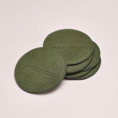 four leather coasters with the name carol rose on them