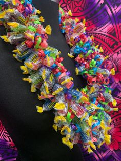 a woman wearing a colorful necklace made out of candy