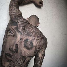 a man with tattoos on his back and shoulder