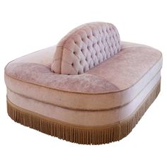 a pink couch sitting on top of a hard wood floor next to a mirror in a room