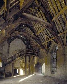 the inside of an old building with wooden beams