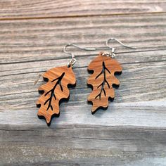 "Don't leaf these elegant wooden earrings out of your collection! Handmade using American Black Walnut Wood, these nature-themed earrings look at home with any outfit from casual to formal wear. These earrings measure 2.75\" tall from the top of the hook to the bottom of the wood and are made to order. The hook and rings are made from Stainless Steel and are unplated, hypoallergenic, and made to last. Leaf design by Stitchbird Graphics." Dremel Carving, Laser Cut Wood Crafts, Engraved Earrings, Wood Burning Crafts, Black Walnut Wood, American Black Walnut, Le Crochet, Wooden Earrings, Laser Cut Wood