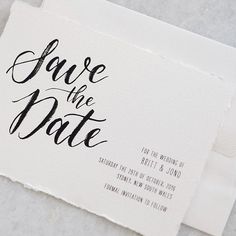 the save the date card is on top of a piece of white paper with black ink