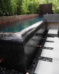 an outdoor hot tub in the middle of a garden